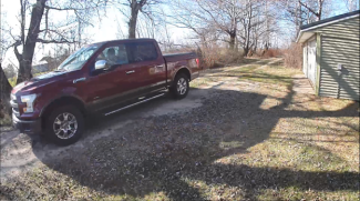 Image of a red pick-up truck taken from an Arlo security camera