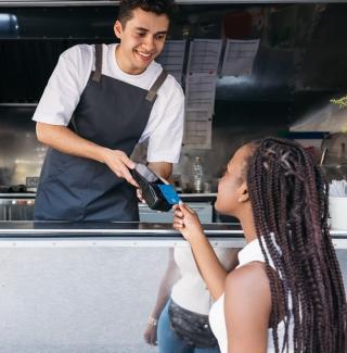 mobile internet for merchants - pos with customer purchasing at food truck